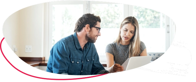 A man and a woman sitting with a laptop at a desk